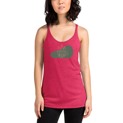 Woman wearing a heather pink racer back tank top with a muted coffee cup and floral design.