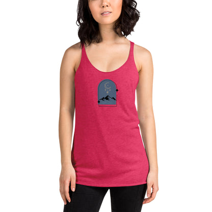 Woman wearing a heather pink racer back tank top with a subtle design of a crescent moon over mountains.