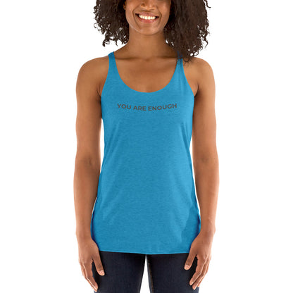 Smiling woman wearing a vintage turquoise racer back tank with "You Are Enough" text.