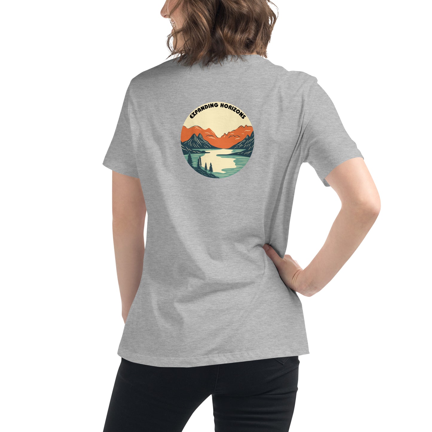 Woman wearing a heather athletic grey relaxed t-shirt featuring a scenic mountain and lake design with 'Expanding Horizons' text