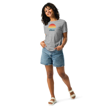 Woman wearing a athletic heather grey relaxed t-shirt with retro 'good vibes' graphic