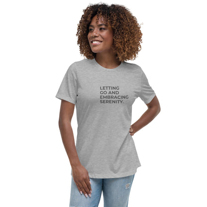 Woman wearing a athletic grey relaxed tee with "Letting Go and Embracing Serenity" printed, available in various colors and sizes from S-3XL.