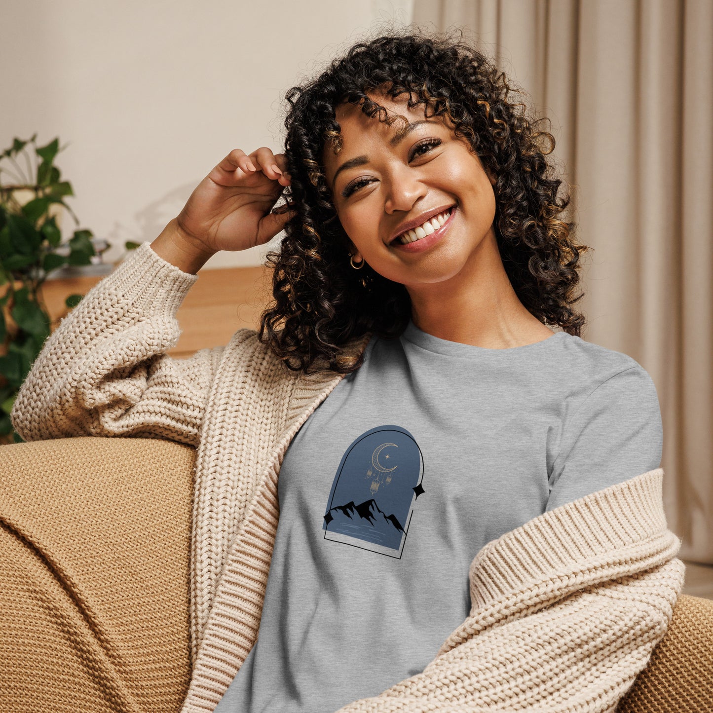 Woman wearing a athletic grey relaxed tee with a tranquil night sky graphic design, representing comfortable and authentic fashion by BYOL.