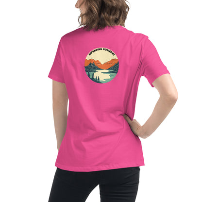 Woman wearing a berry relaxed t-shirt featuring a scenic mountain and lake design with 'Expanding Horizons' text