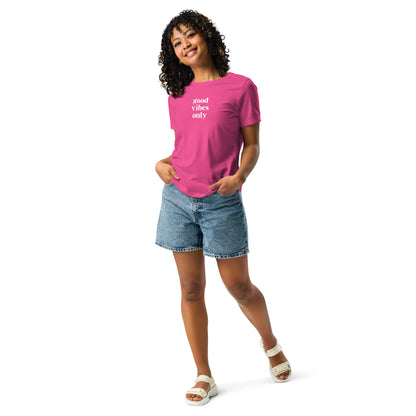 Happy woman wearing a heather pink relaxed t-shirt with 'Good Vibes Only' slogan