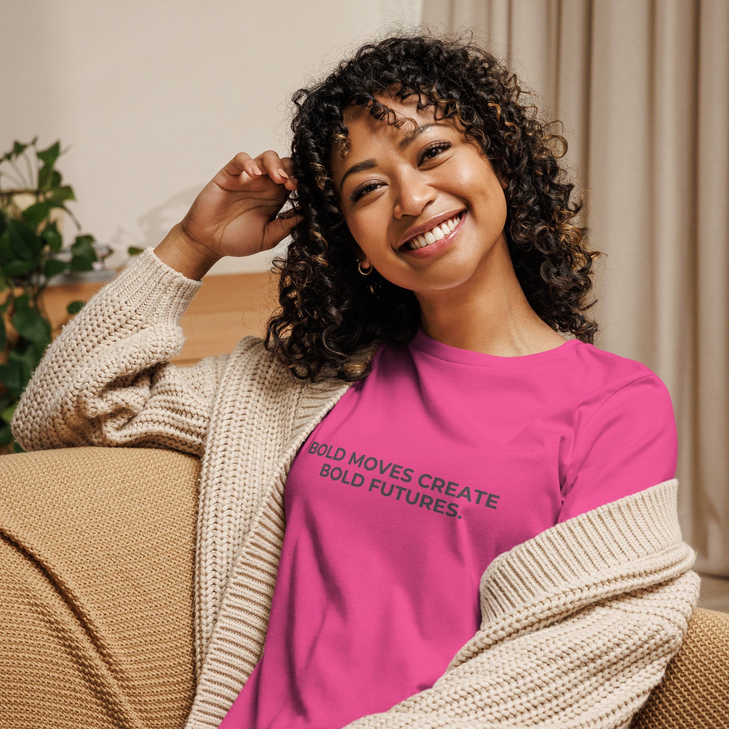 Woman wearing a berry relaxed tee with "Bold Moves Create Bold Futures" printed.