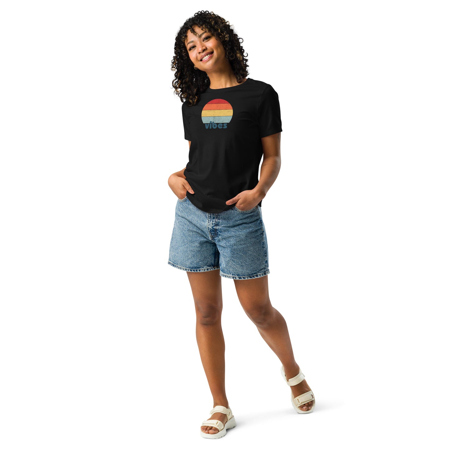 Woman wearing a black relaxed t-shirt with retro 'good vibes' graphic