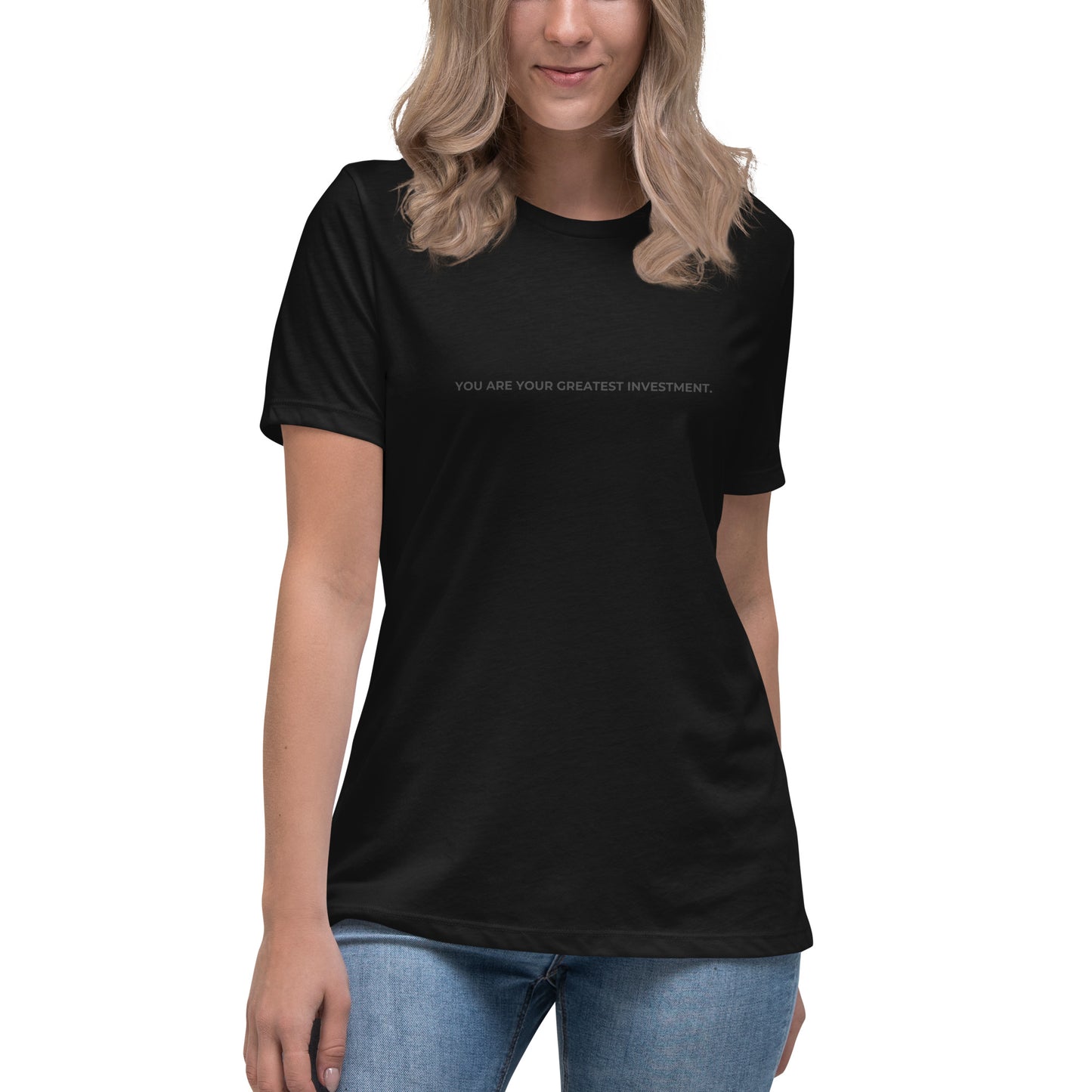 Woman wearing a black relaxed tee with "You Are Your Greatest Investment" printed.