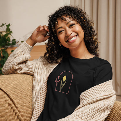 Woman wearing a black relaxed tee with a minimalist tulip window graphic design, representing comfortable and authentic fashion by BYOL.