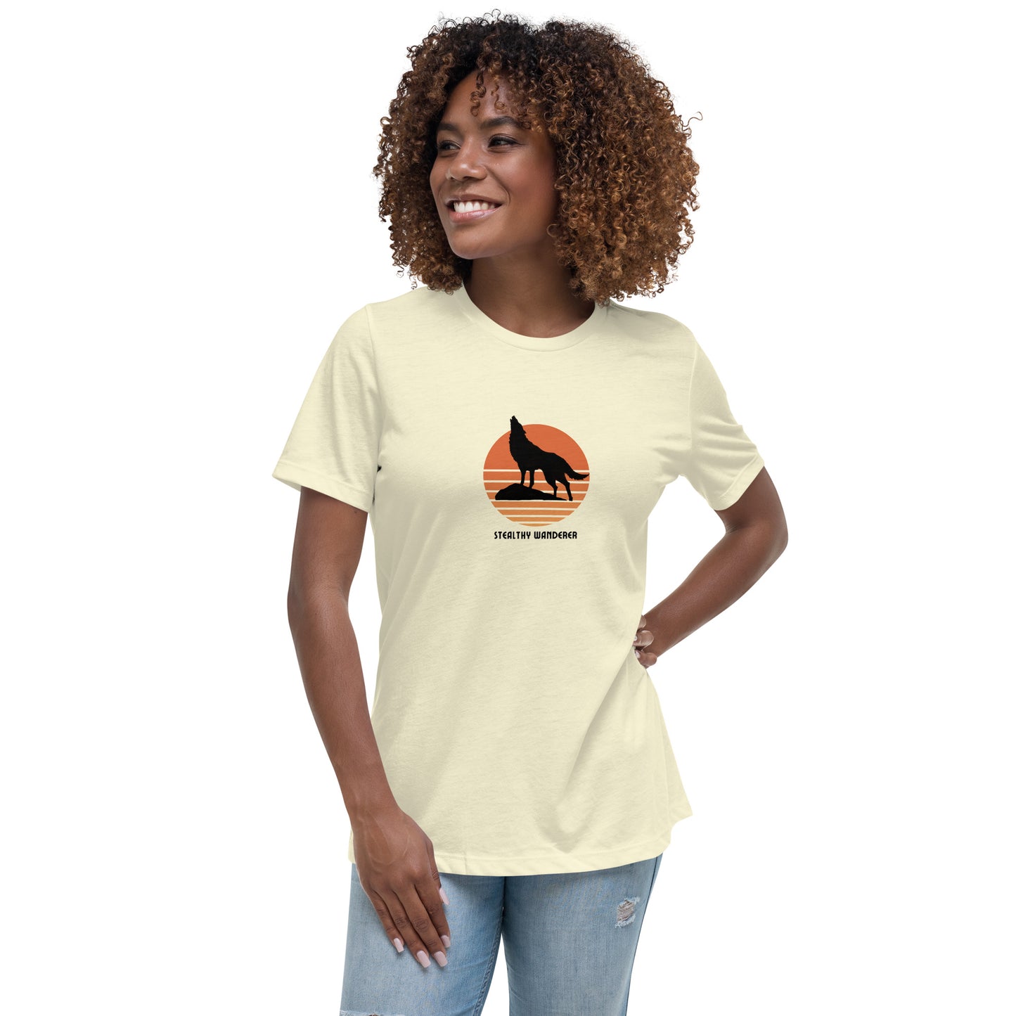 Woman wearing a citron bravery-themed relaxed t-shirt with a wolf graphic and 'Stealthy Wanderer' text in a sunset backdrop