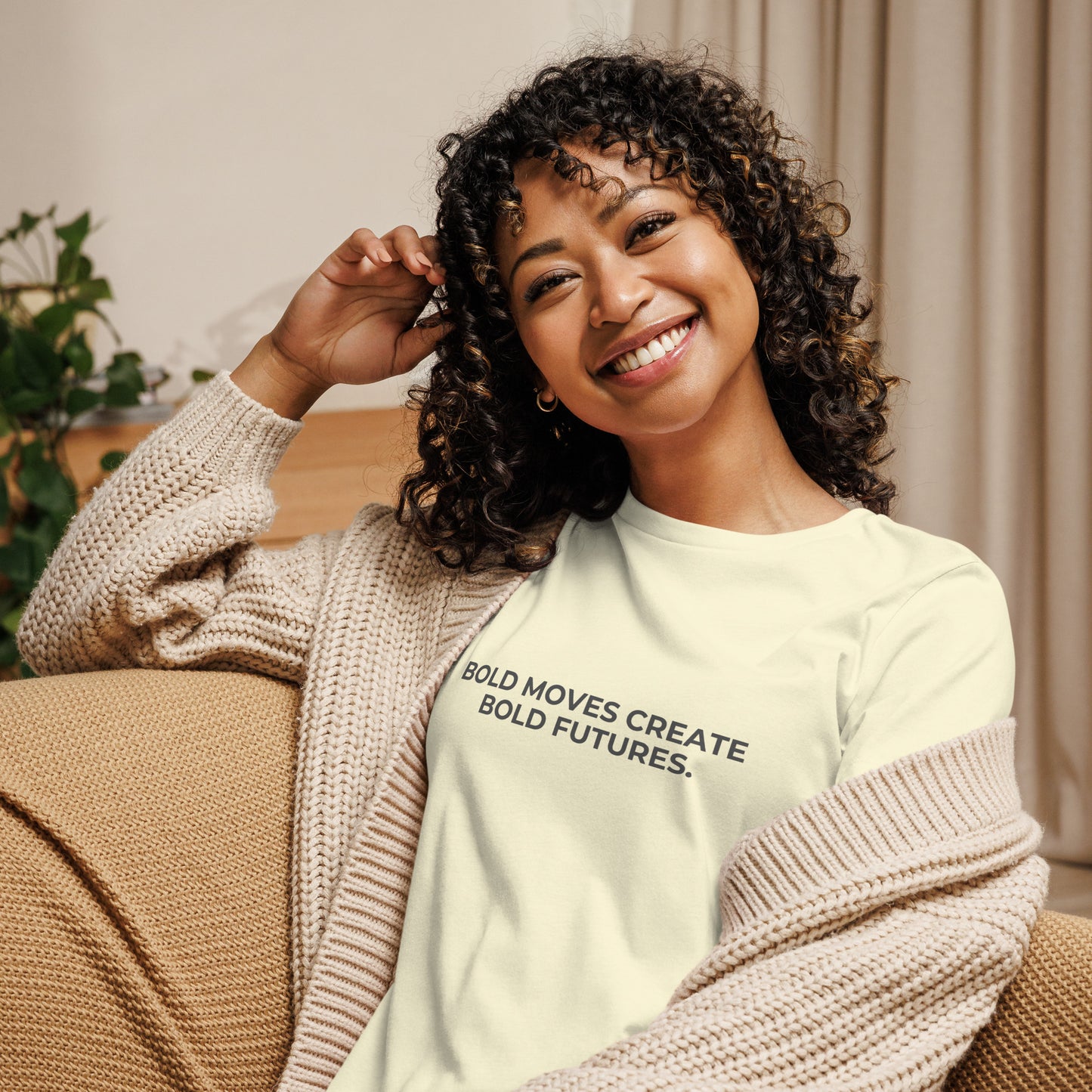 Woman wearing a citron relaxed tee with "Bold Moves Create Bold Futures" printed.