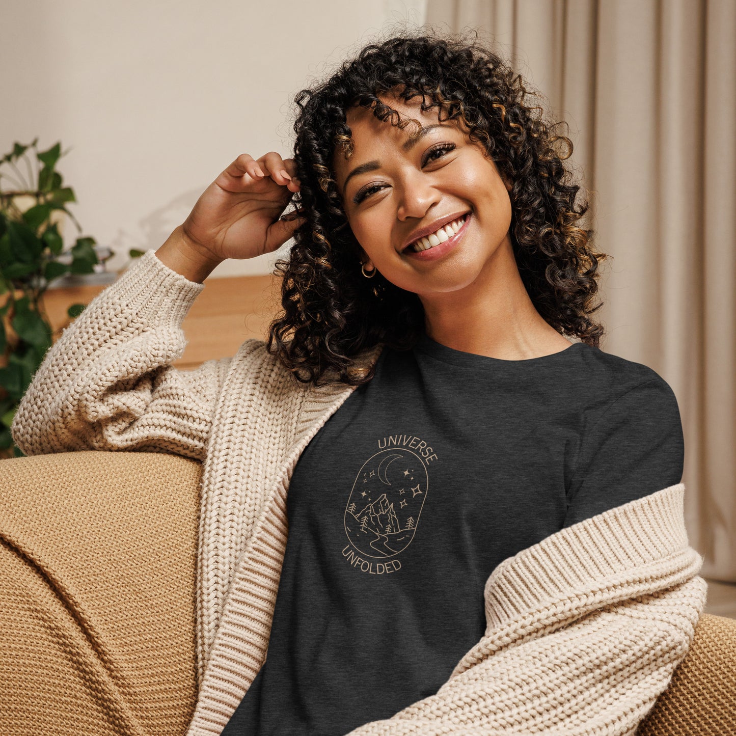 Woman smiling in a heather grey relaxed t-shirt with cosmic universe design