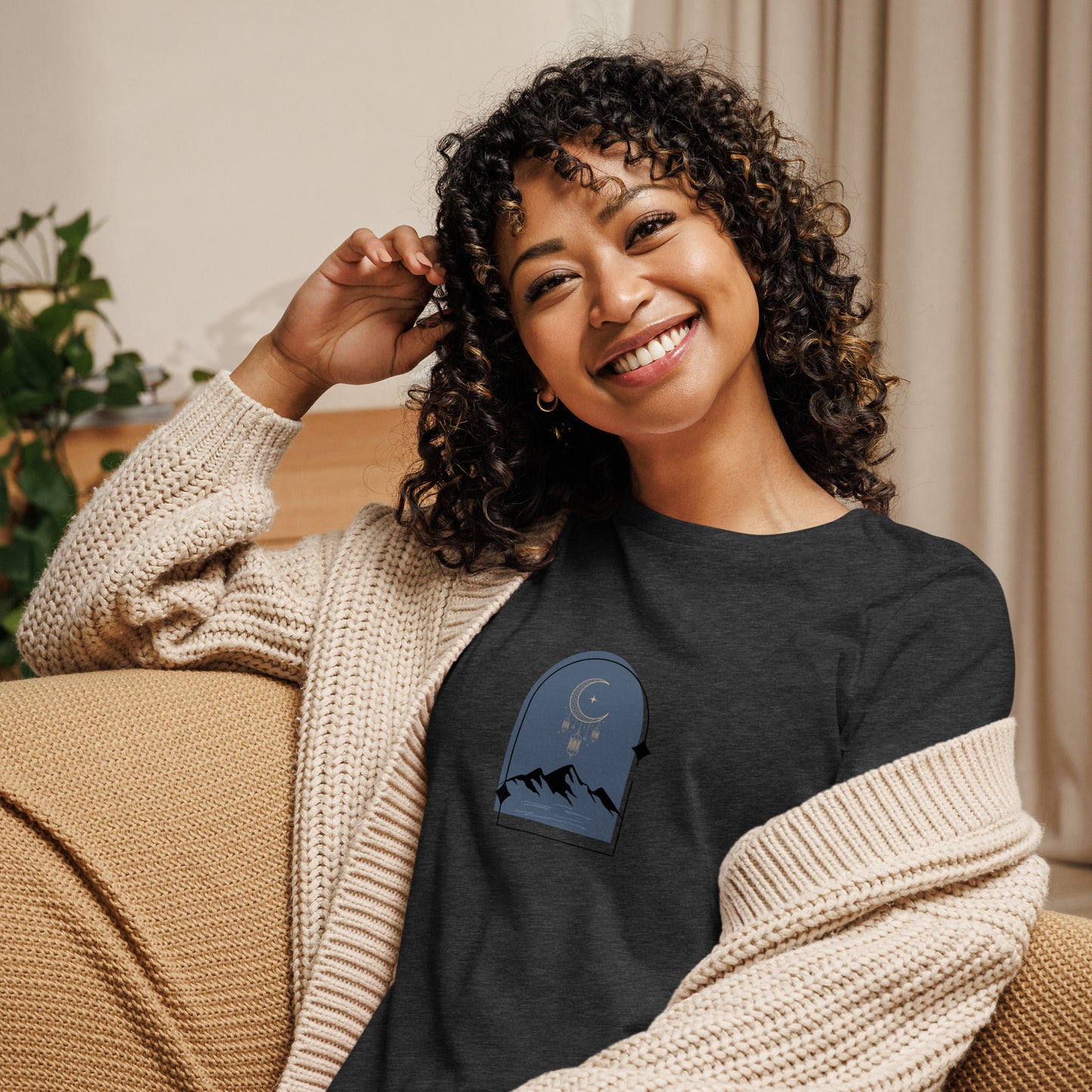 Woman wearing a dark athletic grey heather relaxed tee with a tranquil night sky graphic design, representing comfortable and authentic fashion by BYOL.