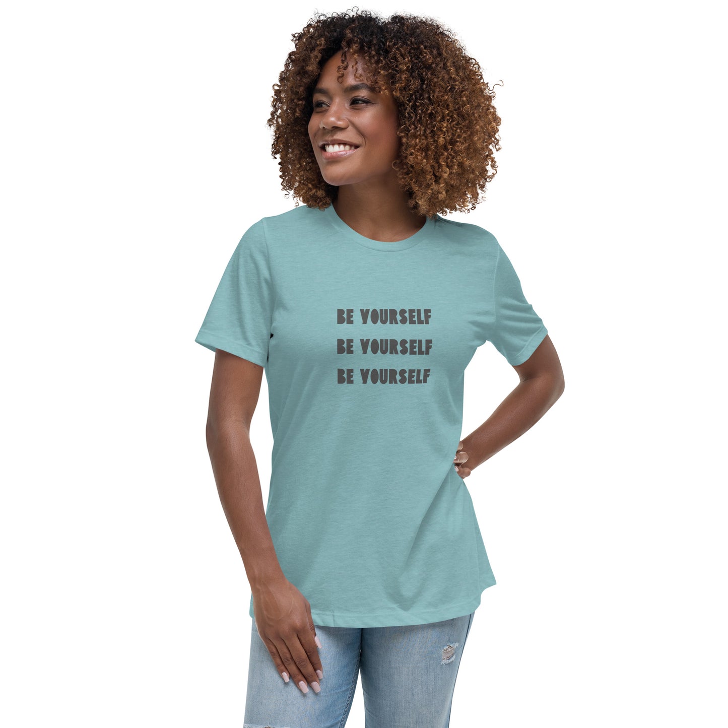 Smiling woman wearing a heather blue relaxed t-shirt with 'Be Yourself' text repeated