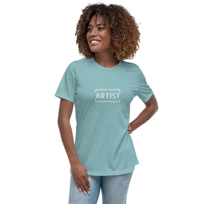 Woman wearing a heather blue relaxed t-shirt labeled 'ARTIST'