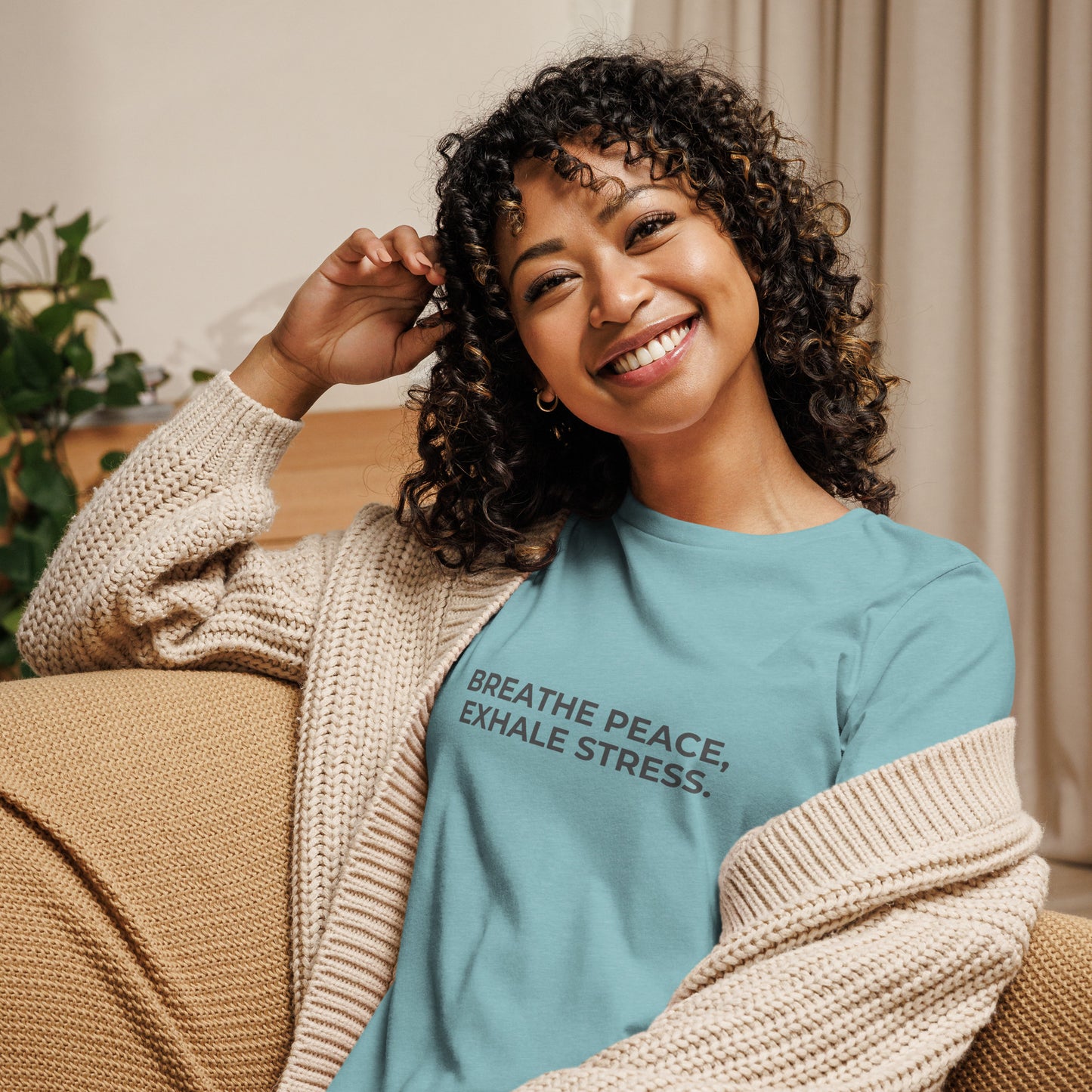 Woman wearing a leaf relaxed tee with "Breathe Peace, Exhale Stress" printed.