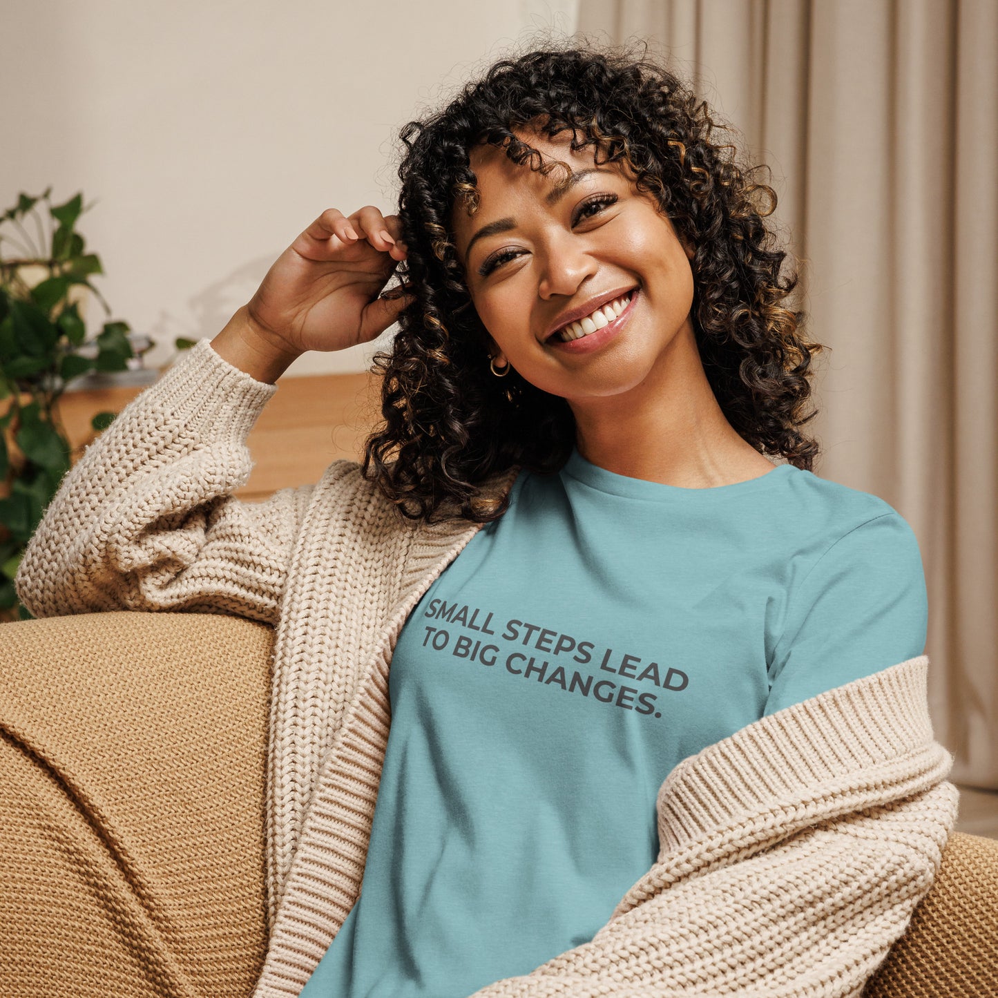 Woman wearing an leaf relaxed tee with "Small Steps Lead to Big Changes" printed.