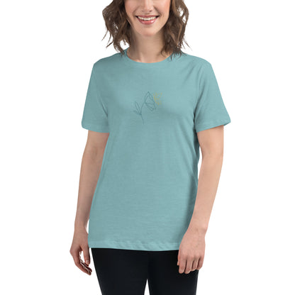 Woman wearing a heather blue lagoon relaxed tee with a minimalist flower graphic design, embodying comfortable and authentic fashion by BYOL.