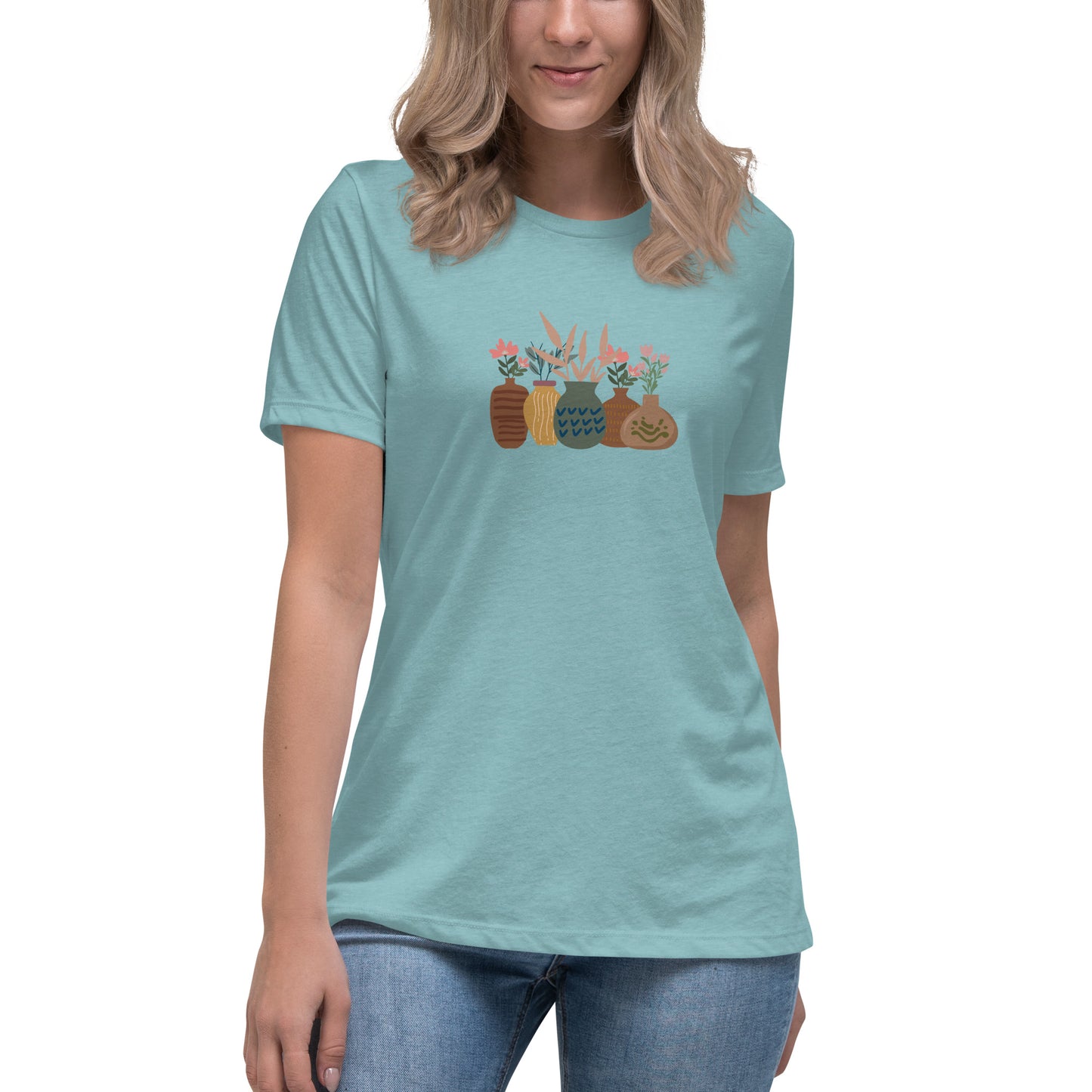 Woman wearing a blue lagoon relaxed tee with a charming vase floral graphic design, embodying comfortable and authentic fashion by BYOL.