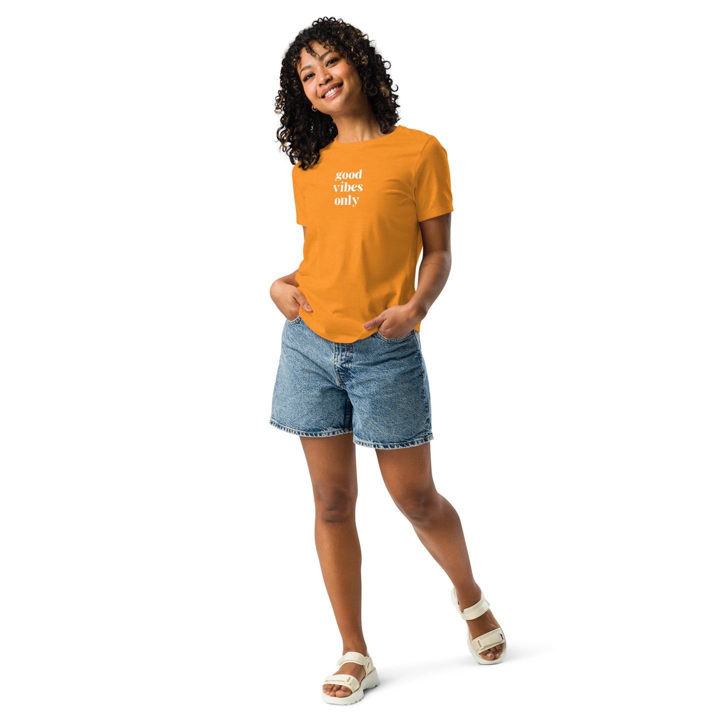 Happy woman wearing a heather orange relaxed t-shirt with 'Good Vibes Only' slogan