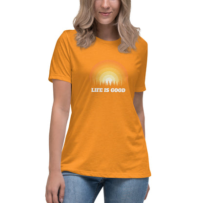 Woman in orange relaxed t-shirt with 'Life Is Good' sunset graphic