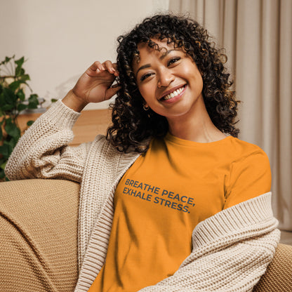 Woman wearing a marmalade relaxed tee with "Breathe Peace, Exhale Stress" printed.