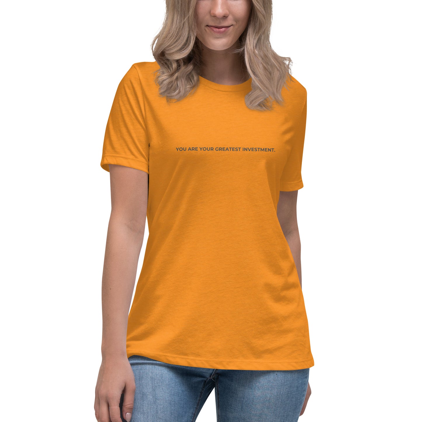 Woman wearing a heather marmalade relaxed tee with "You Are Your Greatest Investment" printed.