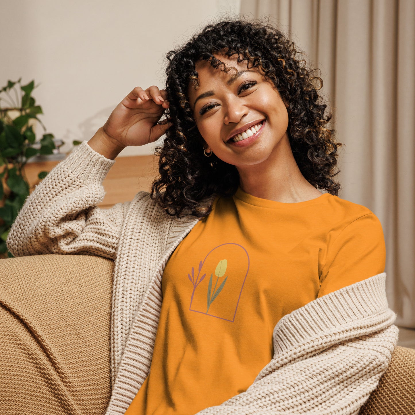 Woman wearing a heather marmalade relaxed tee with a minimalist tulip window graphic design, representing comfortable and authentic fashion by BYOL.