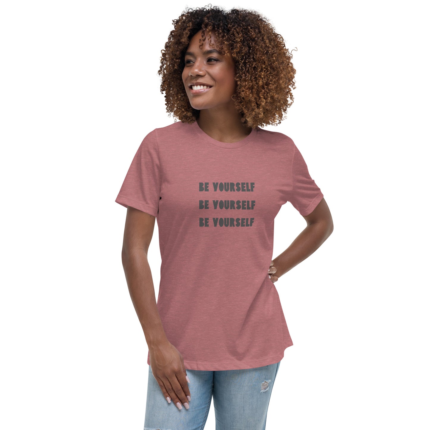 Smiling woman wearing a heather mauve relaxed t-shirt with 'Be Yourself' text repeated