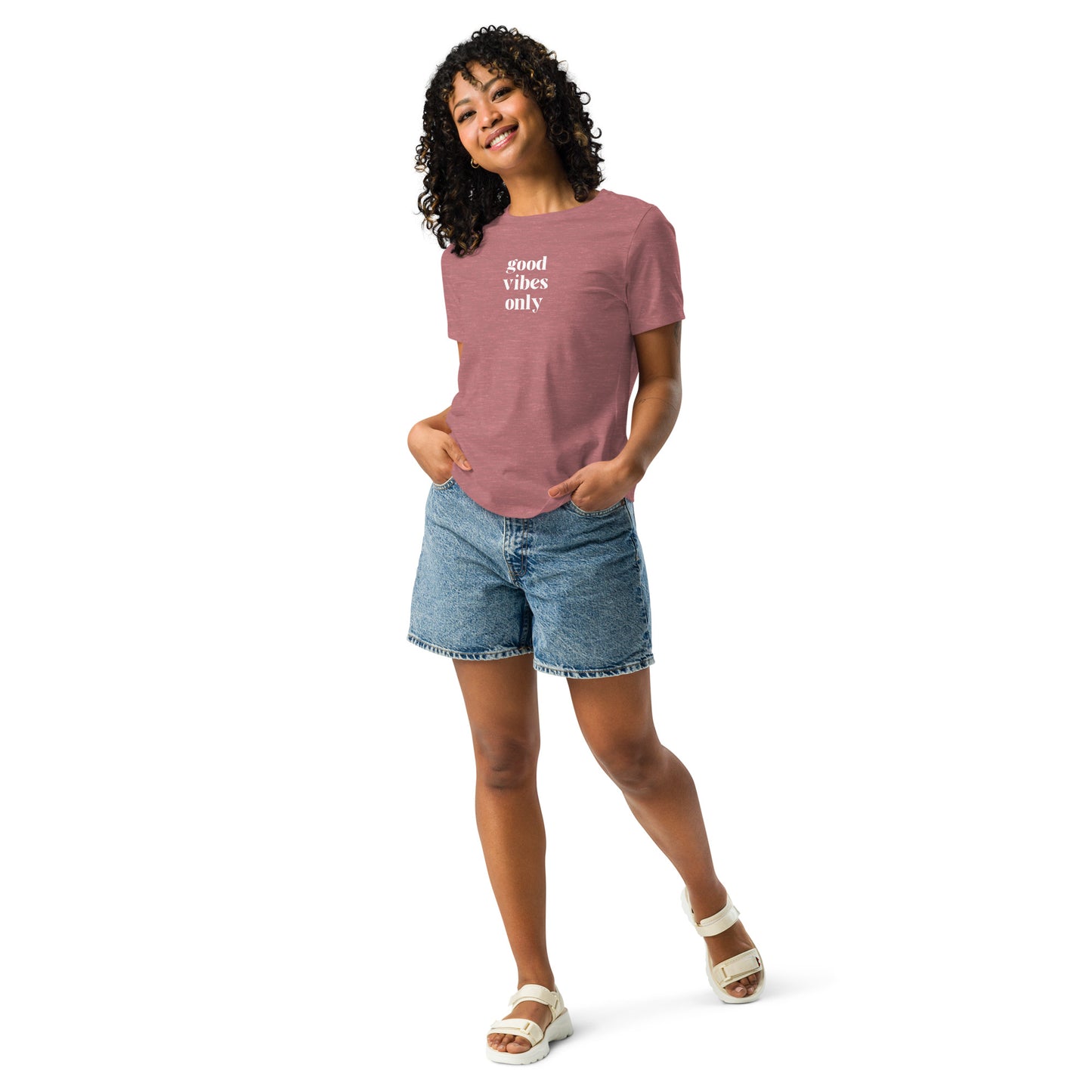 Happy woman wearing a heather mauve relaxed t-shirt with 'Good Vibes Only' slogan