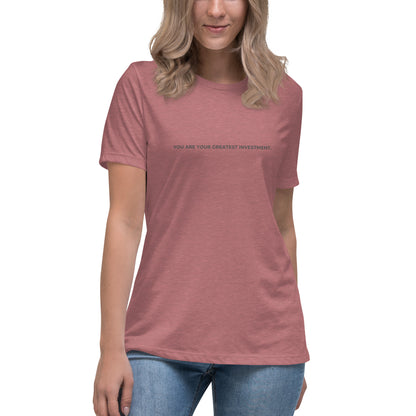 Woman wearing a heather mauve relaxed tee with "You Are Your Greatest Investment" printed.