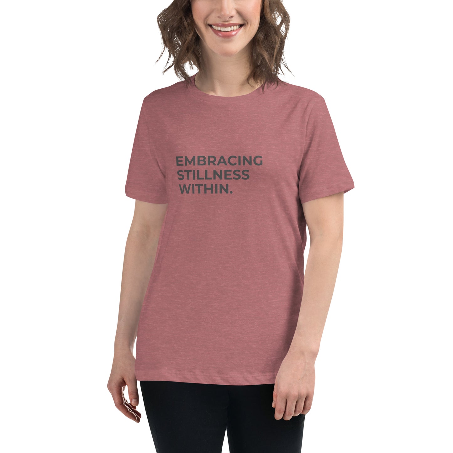 Woman wearing a heather mauve relaxed tee with "Embracing Stillness Within" printed.