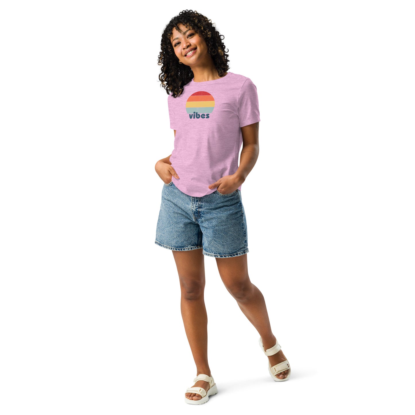 Woman wearing a heather lilac relaxed t-shirt with retro 'good vibes' graphic