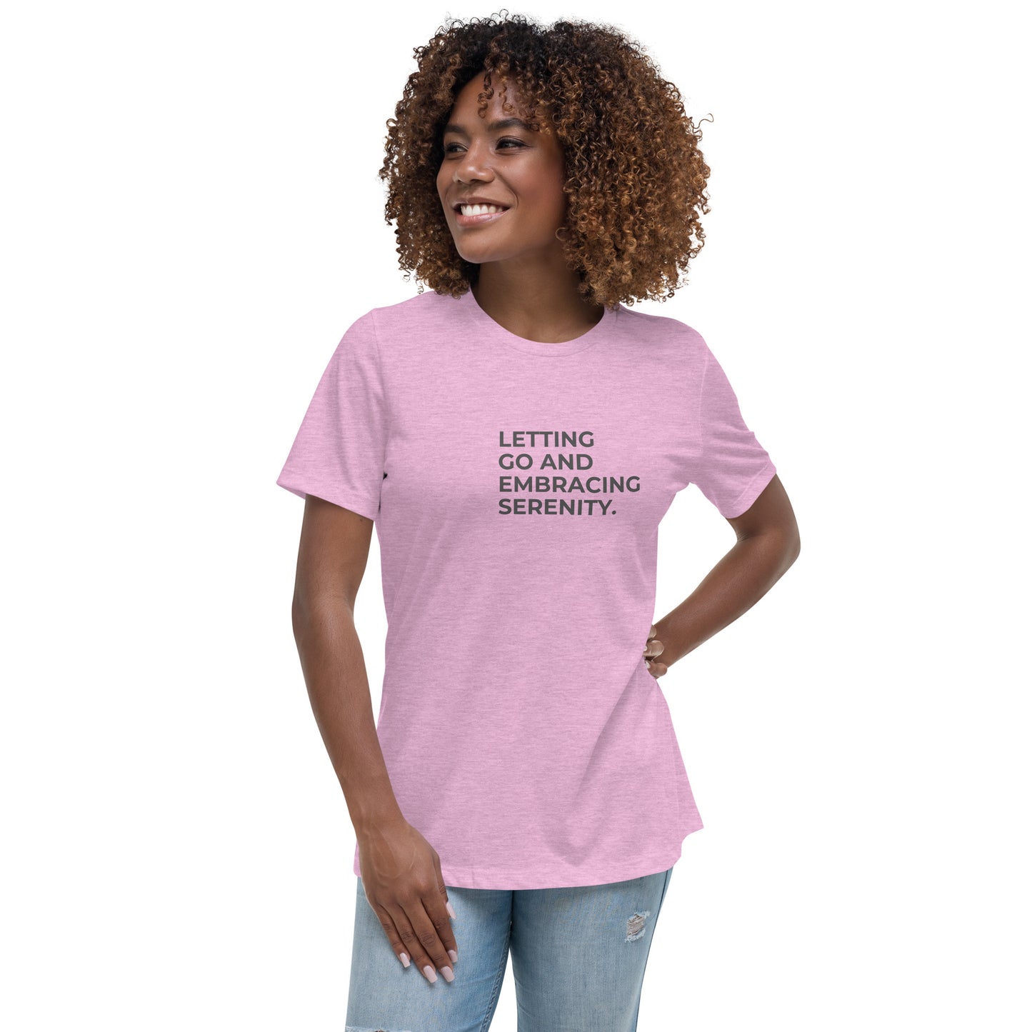 Woman wearing a heather prism lilac relaxed tee with "Letting Go and Embracing Serenity" printed, available in various colors and sizes from S-3XL.