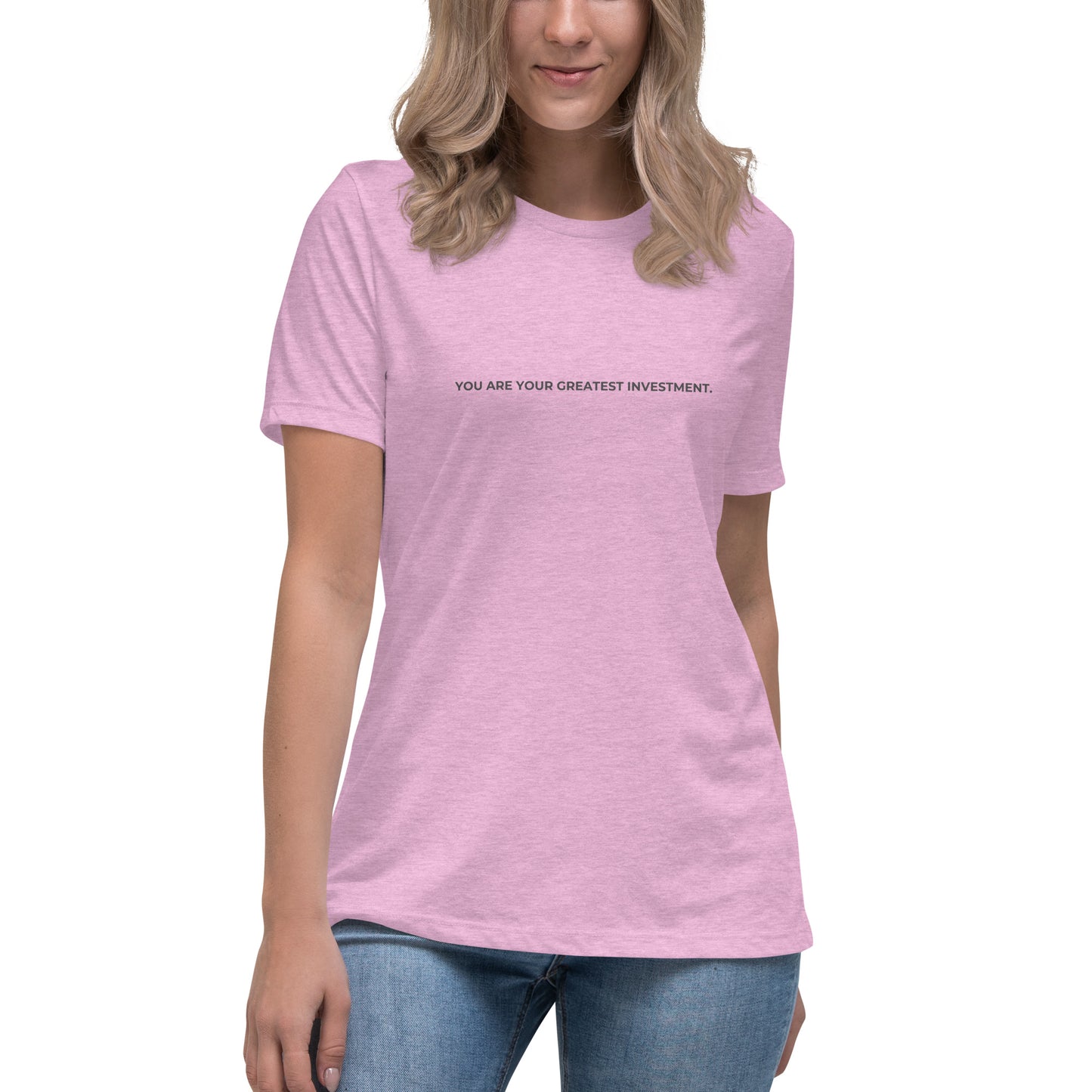 Woman wearing a heather prism lilac relaxed tee with "You Are Your Greatest Investment" printed.