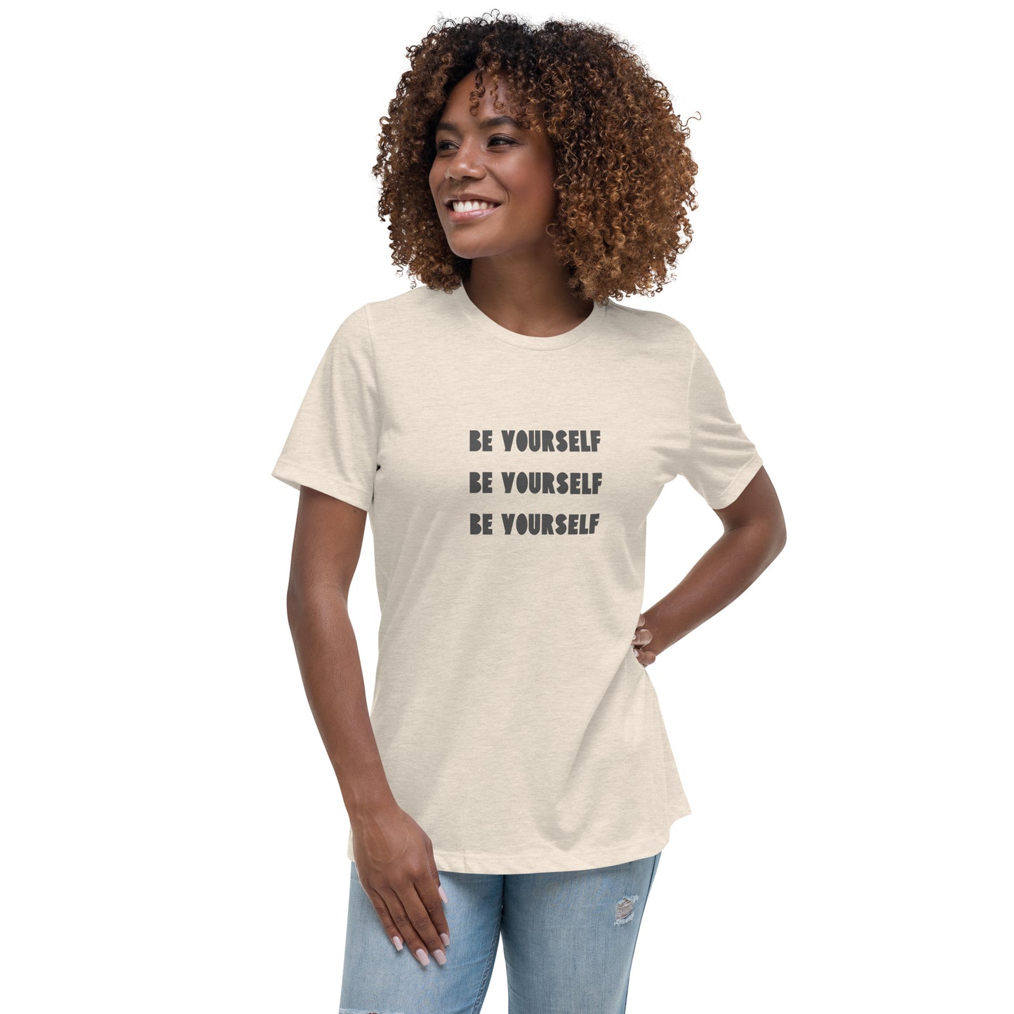 Smiling woman wearing a heather natural relaxed t-shirt with 'Be Yourself' text repeated