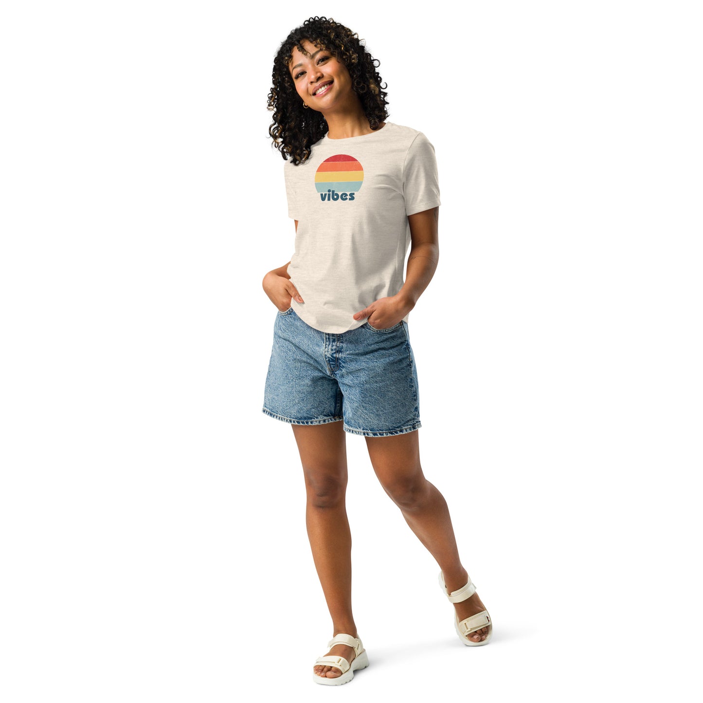 Woman wearing a heather natural relaxed t-shirt with retro 'good vibes' graphic