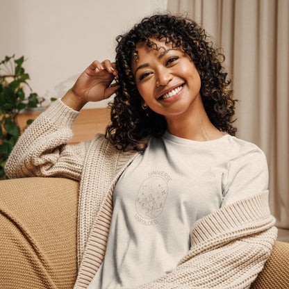 Woman smiling in a heather natural relaxed t-shirt with cosmic universe design