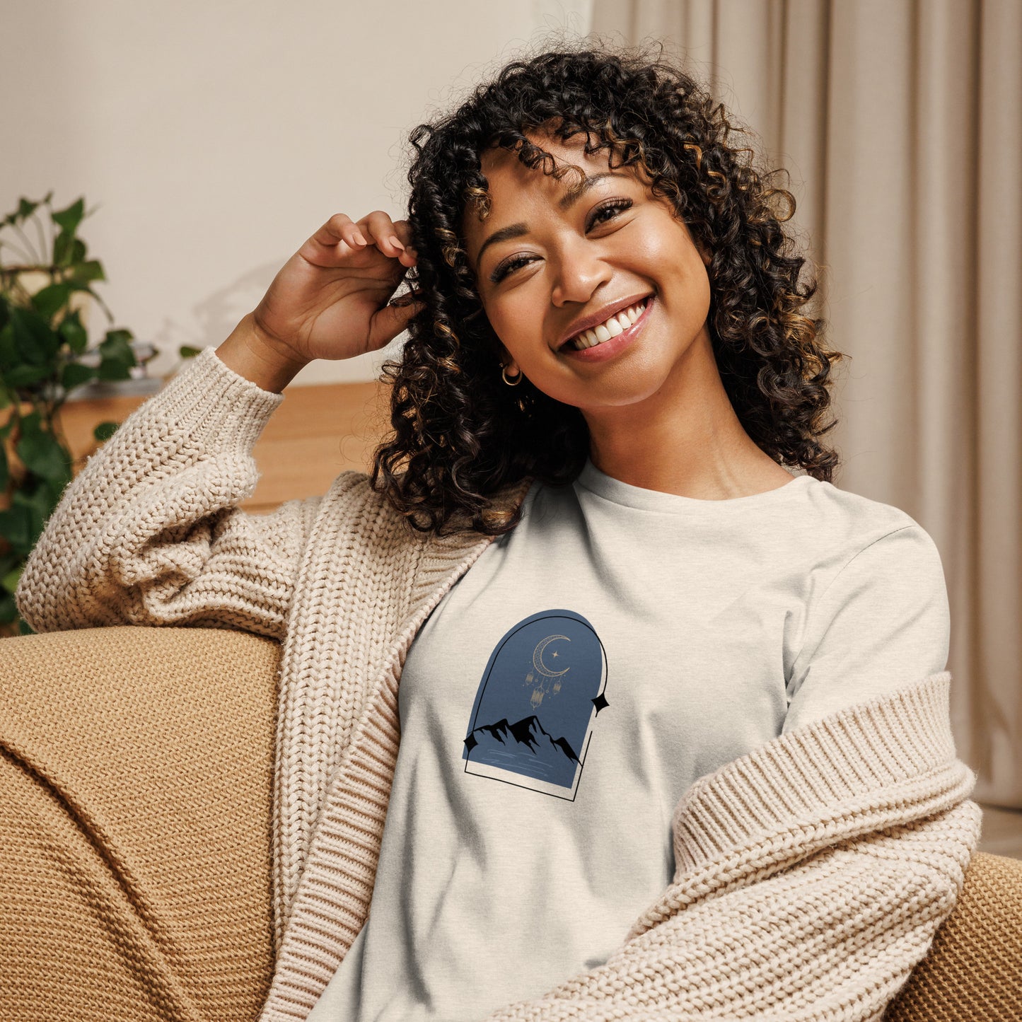 Woman wearing a heather prism natural relaxed tee with a tranquil night sky graphic design, representing comfortable and authentic fashion by BYOL.