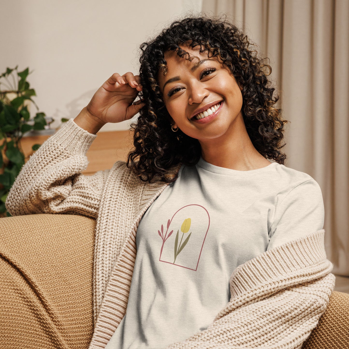 Woman wearing a heather prism natural relaxed tee with a minimalist tulip window graphic design, representing comfortable and authentic fashion by BYOL.