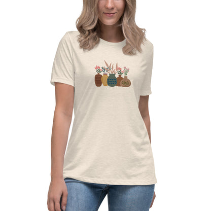 Woman wearing a heather prism natural relaxed tee with a charming vase floral graphic design, embodying comfortable and authentic fashion by BYOL.