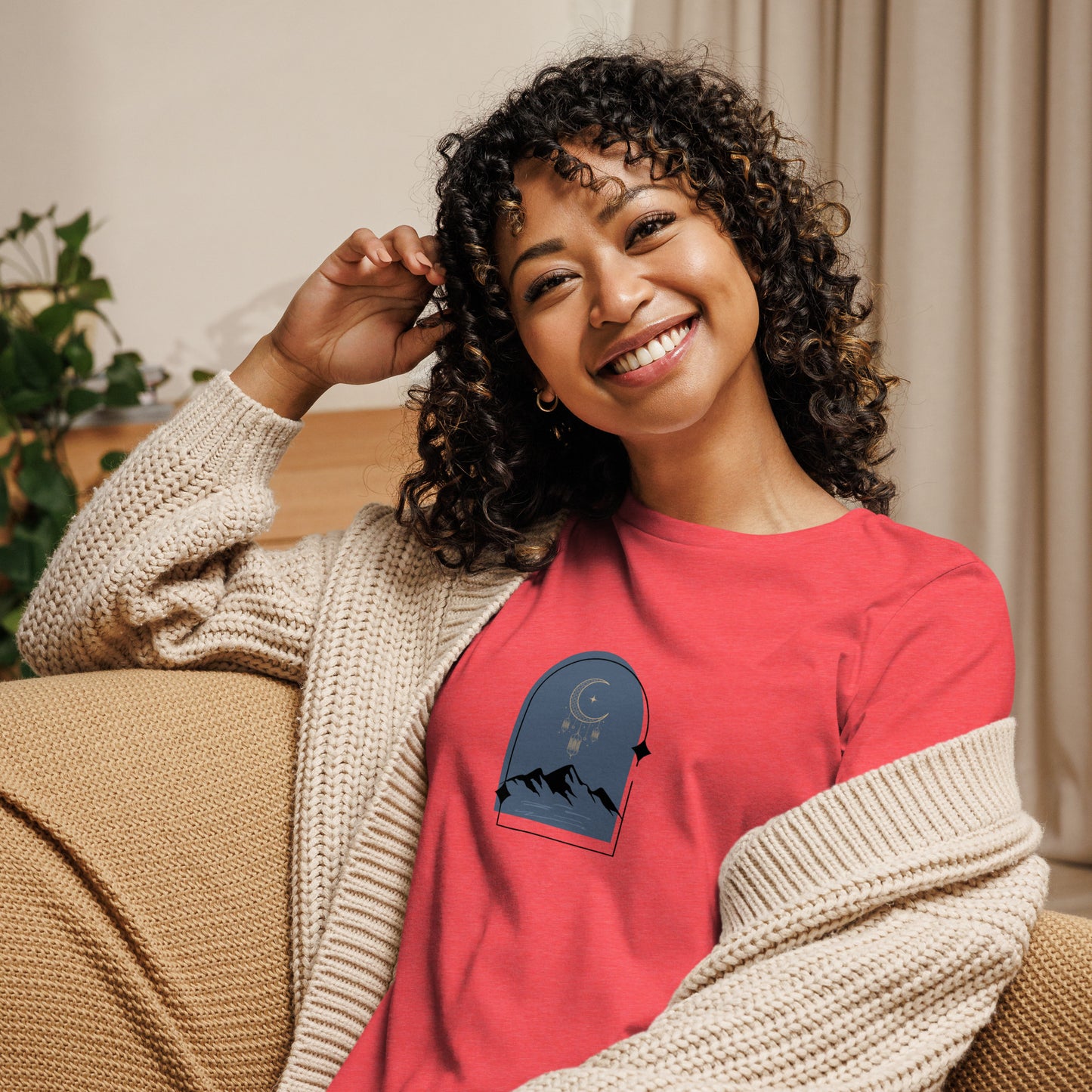 Woman wearing a heather red relaxed tee with a tranquil night sky graphic design, representing comfortable and authentic fashion by BYOL.