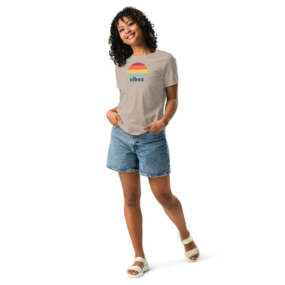 Woman wearing a stone relaxed t-shirt with retro 'good vibes' graphic