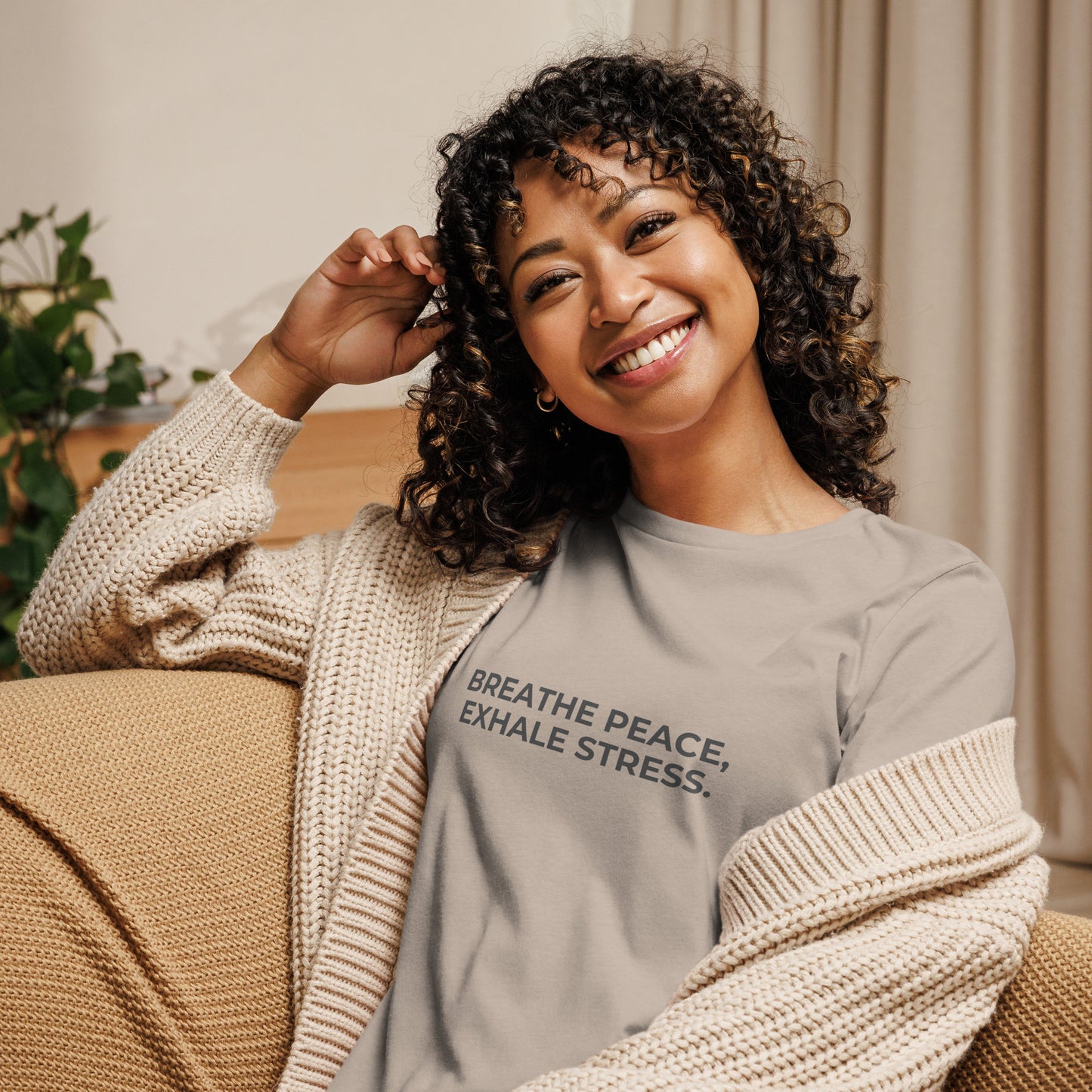 Woman wearing a stone relaxed tee with "Breathe Peace, Exhale Stress" printed.