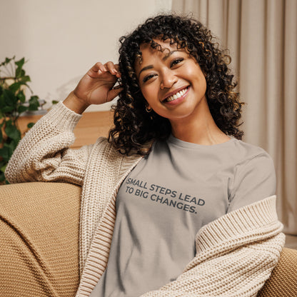 Woman wearing an stone relaxed tee with "Small Steps Lead to Big Changes" printed.