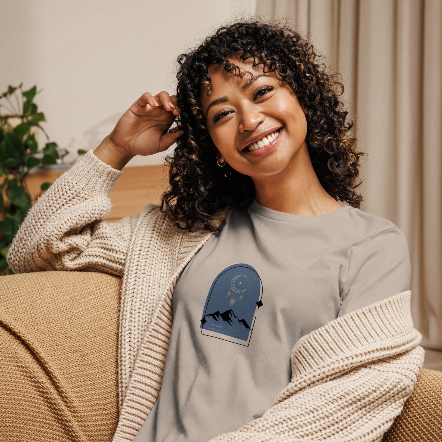 Woman wearing a heather stone relaxed tee with a tranquil night sky graphic design, representing comfortable and authentic fashion by BYOL.