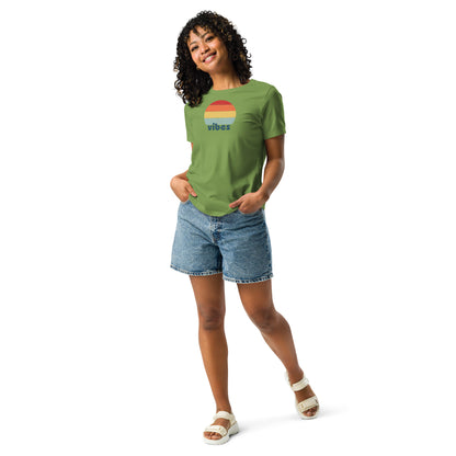 Woman wearing a leaf green relaxed t-shirt with retro 'good vibes' graphic