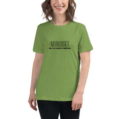 Woman wearing a leaf green relaxed t-shirt with the phrase "Mindset is Everything" printed in black.