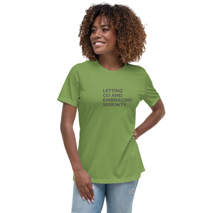 Woman wearing a leaf relaxed tee with "Letting Go and Embracing Serenity" printed, available in various colors and sizes from S-3XL.