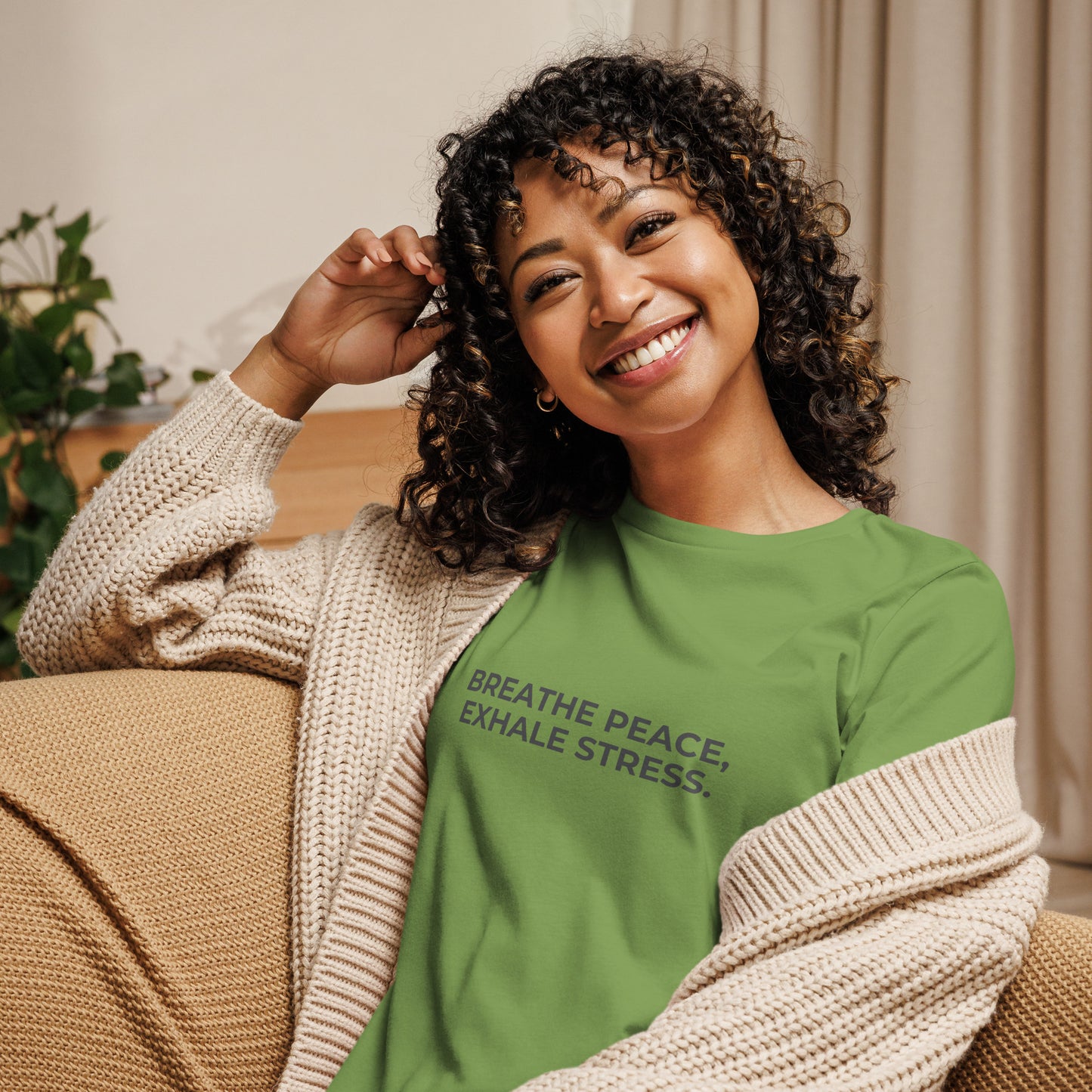 Woman wearing a leaf relaxed tee with "Breathe Peace, Exhale Stress" printed.